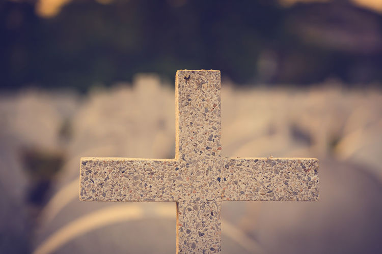 Close-up of cross in cemetery