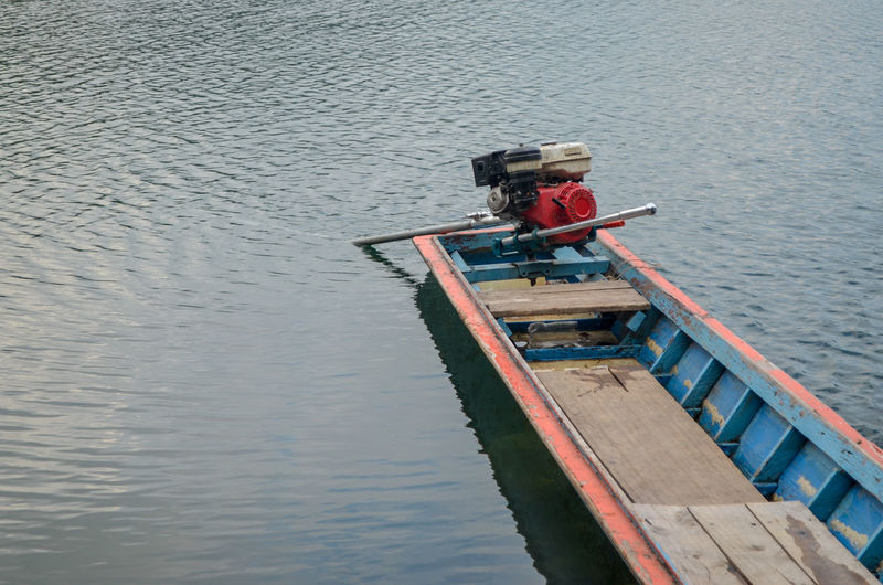 High angle view of man sitting on boat in lake