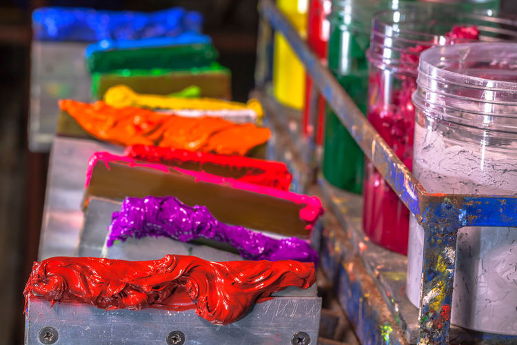 Close-up of colorful paints in containers for sale