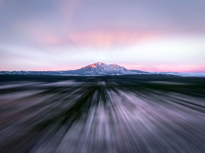 Scenic view of snowcapped mountains against sky during sunset