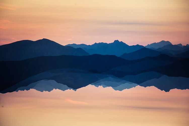 Colorful, abstract double exposure of mountains in sunrise. 