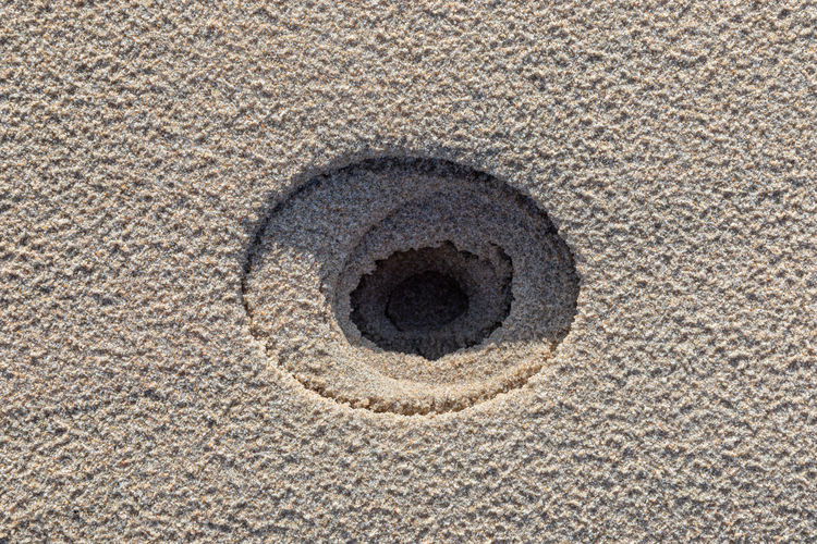 High angle view of hole on sand