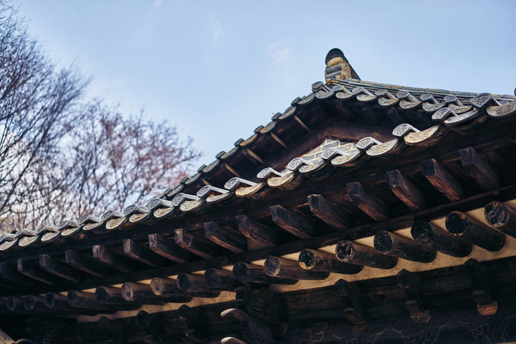 High section of traditional building roof against clear sky