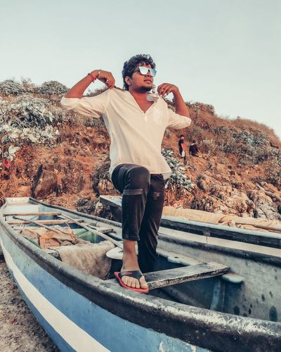 Full length of man wearing sunglasses standing on boat