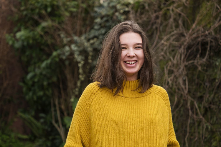Portrait of smiling young woman in park
