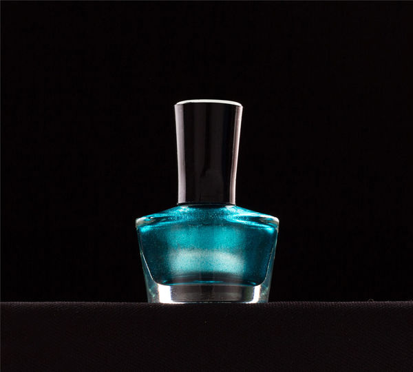 Close-up of empty glass bottle against black background