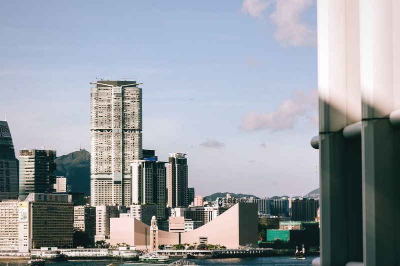 View of skyscrapers against cloudy sky
