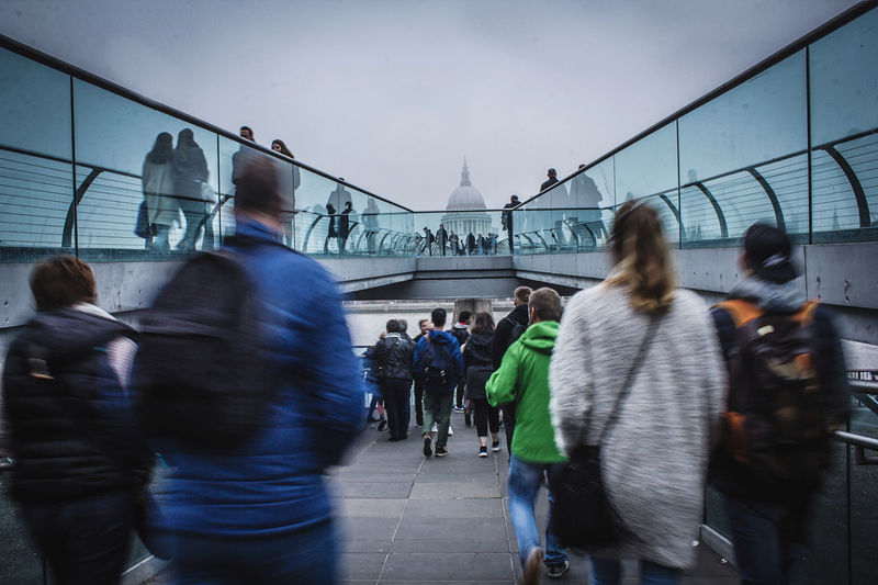 Rear view of people walking on street