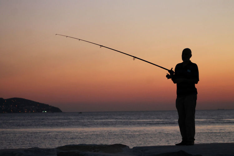 A silhouette of a fisherman at istanbul, turkey.