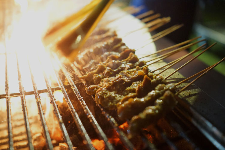 Close-up of satay on barbecue for sale at market