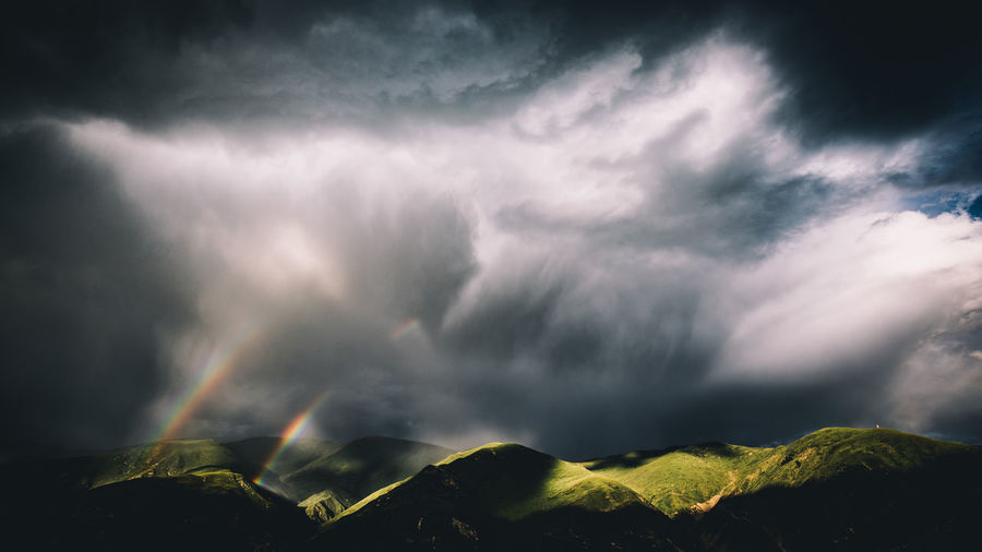 Scenic view of rainbow against cloudy sky