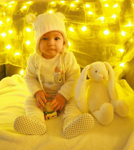 Portrait of cute baby girl sitting