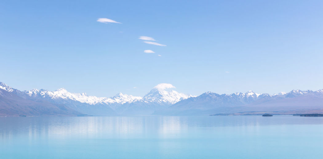 Scenic view of snowcapped mountains by lake pukaki