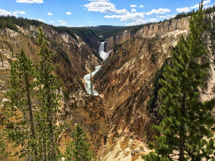 Idyllic view of waterfall amidst mountains at yellowstone national park