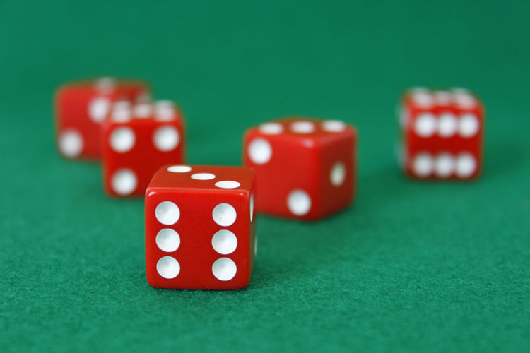Close-up of red dice on green table