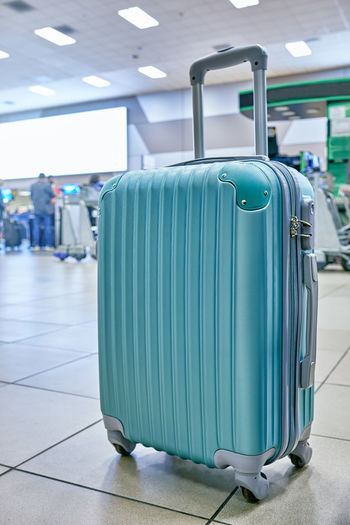 Suitcase or baggage with airport luggage trolley in the international airport, focus on suitcases. 