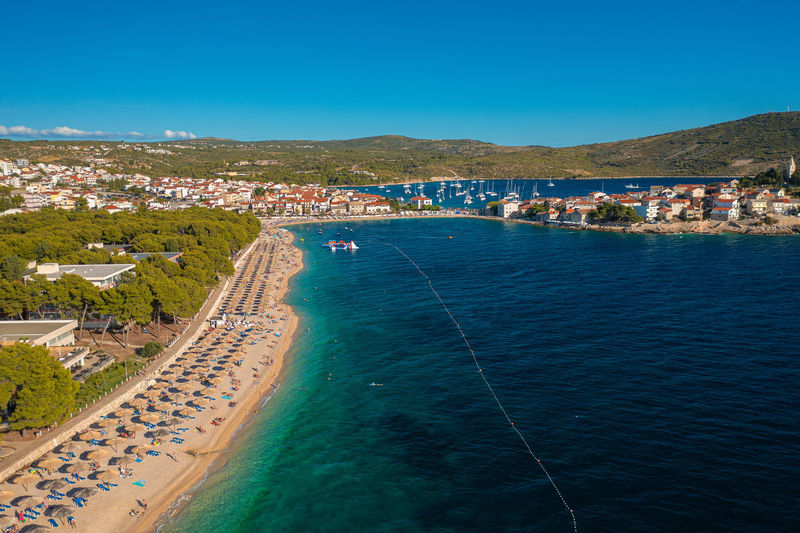 Aerial scene of the beach and hotels in primosten town the coast of the adriatic sea, croatia