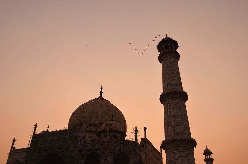 Low angle view of taj mahal against sky during sunset