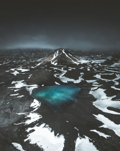 Scenic view of frozen pond against sky during winter