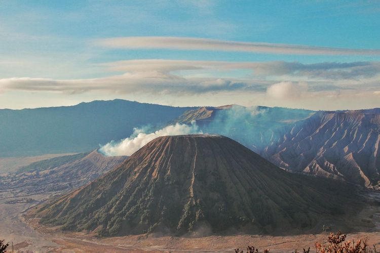 Panoramic view of volcanic landscape against cloudy sky