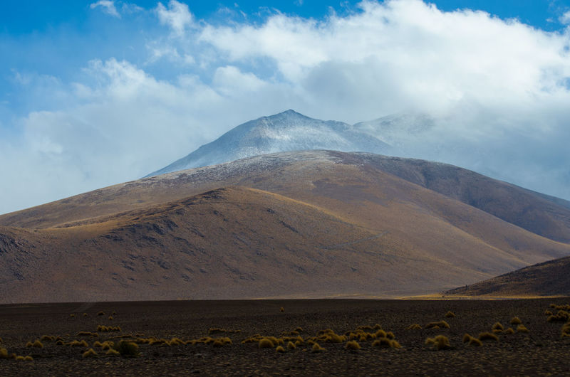 Idyllic view of mountains at atacama desert against cloudy sky