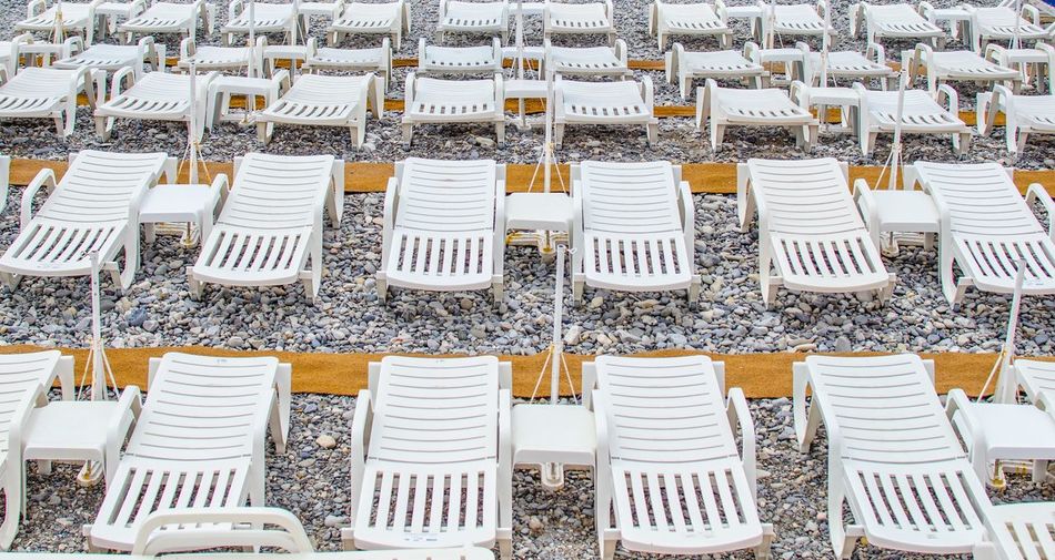 High angle view of lounge chairs at beach
