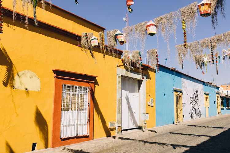 Street decorated for a festive celebration lined by colorful houses in oaxaca, mexico