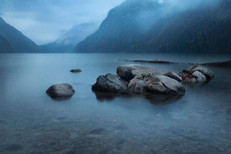 Scenic view of lake and mountains against sky