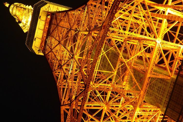 Low angle view of illuminated tokyo tower against clear sky at night