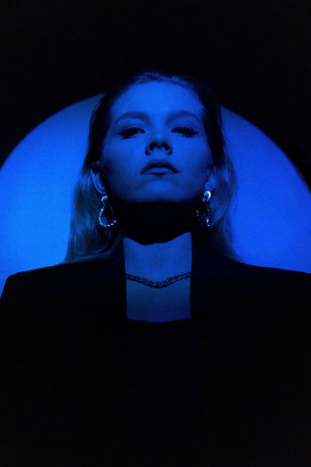 Portrait of a young woman in blue light. the weekend style