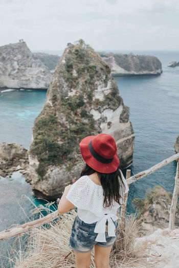 Young pretty asian woman feeling relax with ocean and mountain view in bali.
