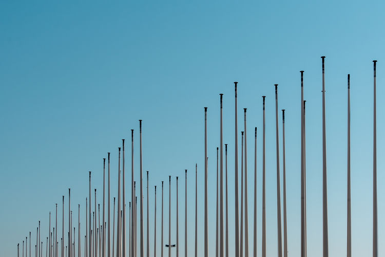 Low angle view of metal pole against clear blue sky