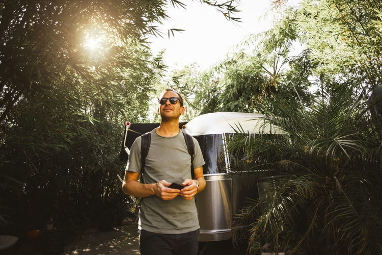 Man looking away while walking by motor home