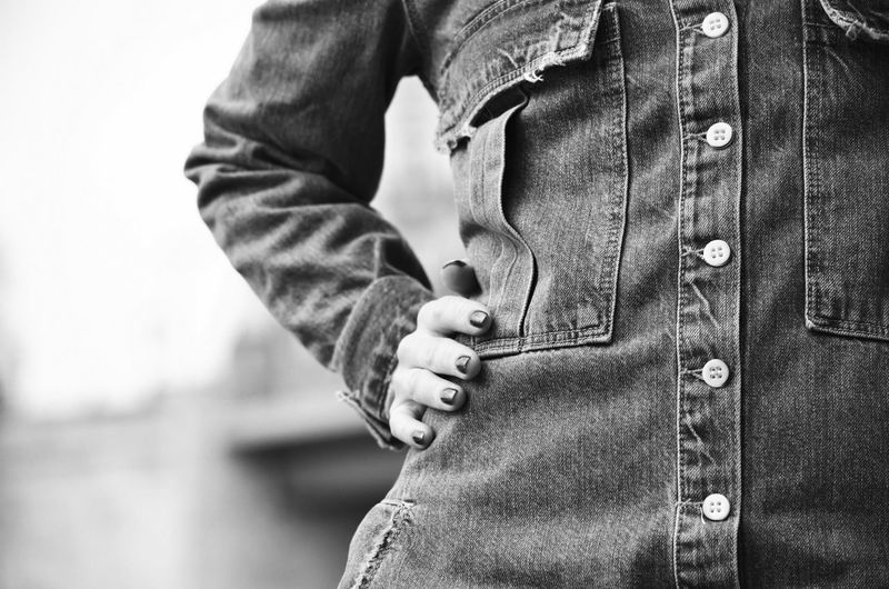 Close-up mid section of a woman in denim shirt