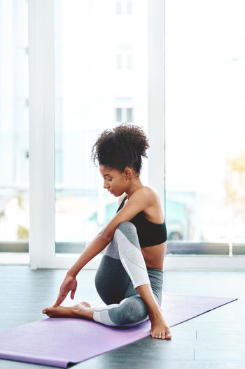 Woman doing yoga on exercise mat