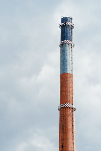 Low angle view of smoke stack against sky