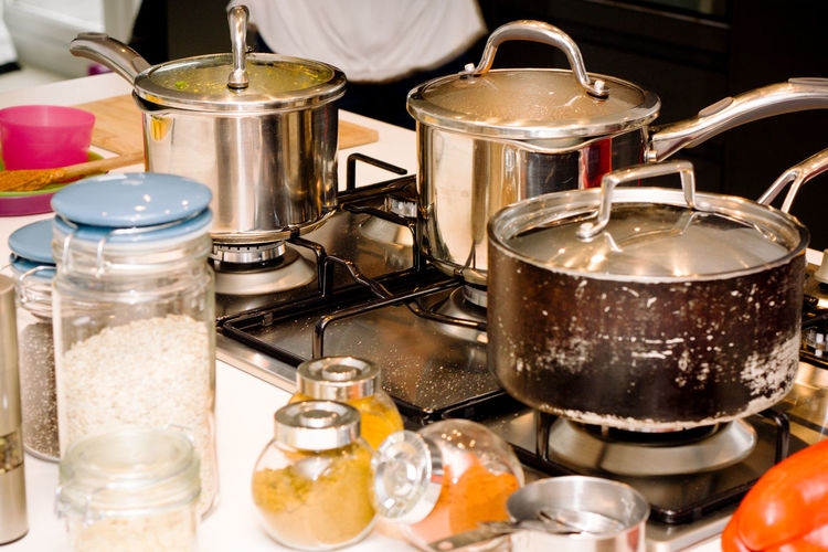 High angle view of cooking pans on gas in kitchen