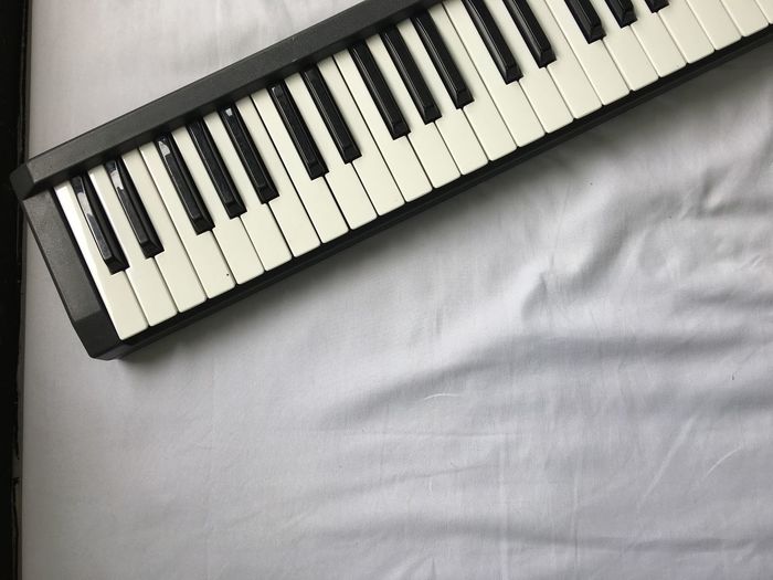 High angle view of piano on bed