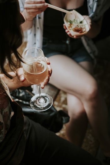 Dinner Asian Food Celebration Chopsticks Drink Drinking Food And Drink Friendship Glass Group Of People Holding Lifestyles Real People Sitting Socializing Togetherness Vegan Food Wine Wineglass Women