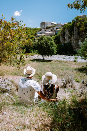 Rear view of man sitting on field