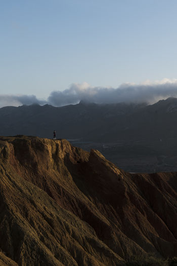 Woman on old abandoned mine view the mountains with clouds background in murcia, spain
