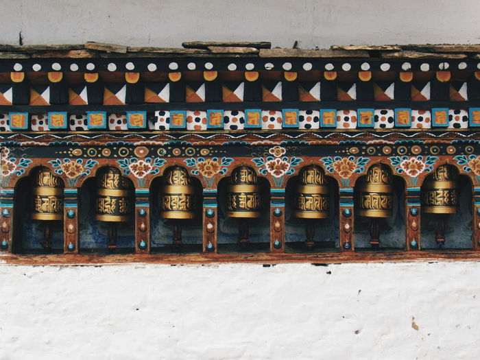 Prayer wheels on temple wall