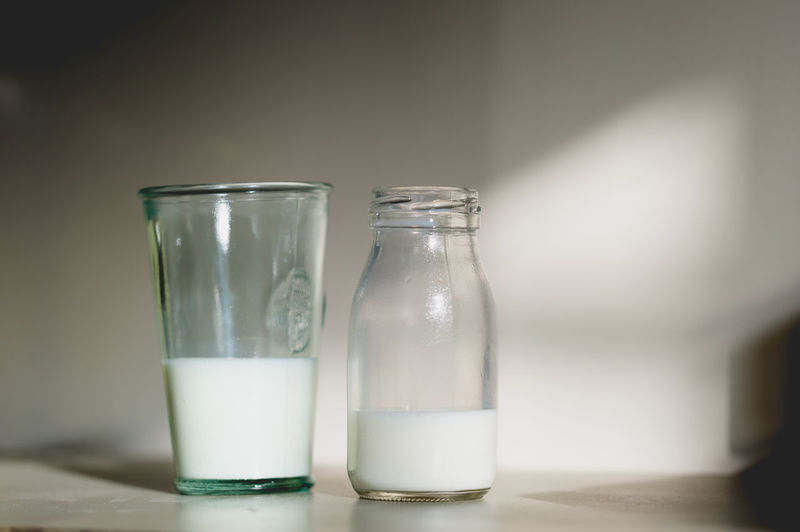 Close-up of milk in glass and bottle