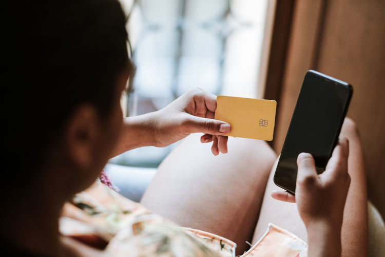 Ethnic woman shopping online at home