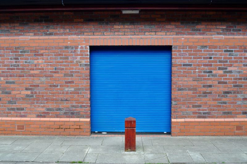 Closed blue shutter of building