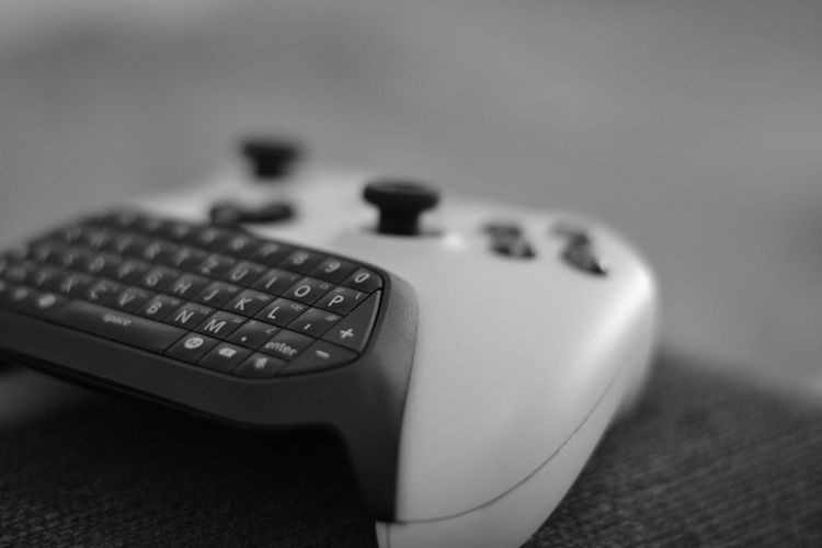 Close-up of game controller on seat
