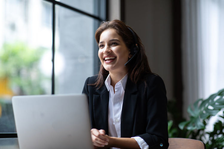 Portrait of a smiling young woman working at office