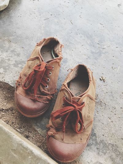 High angle view of weathered shoes