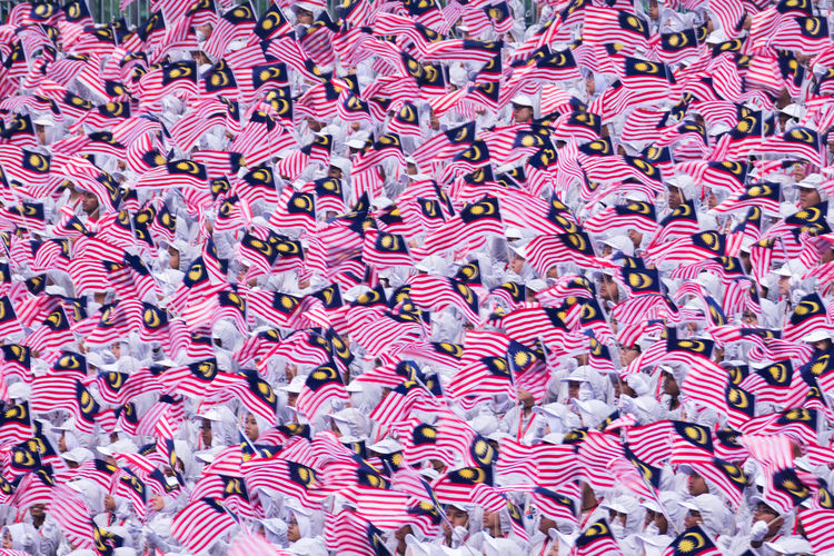 High angle view of crowd waving malaysian flag