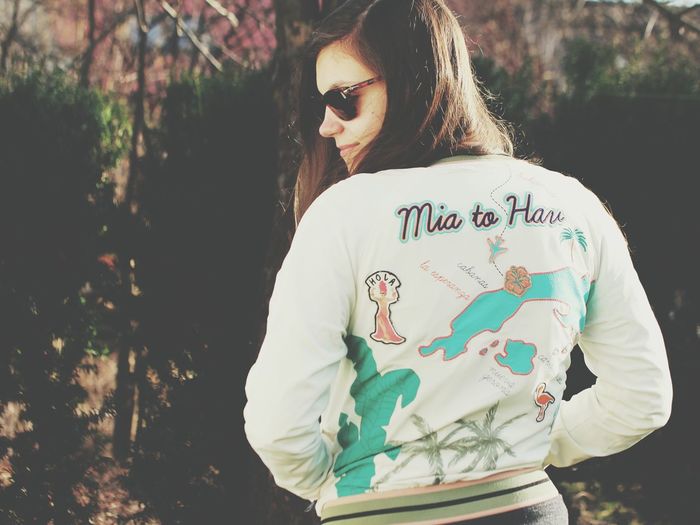 Rear view of woman wearing embroidered jacket